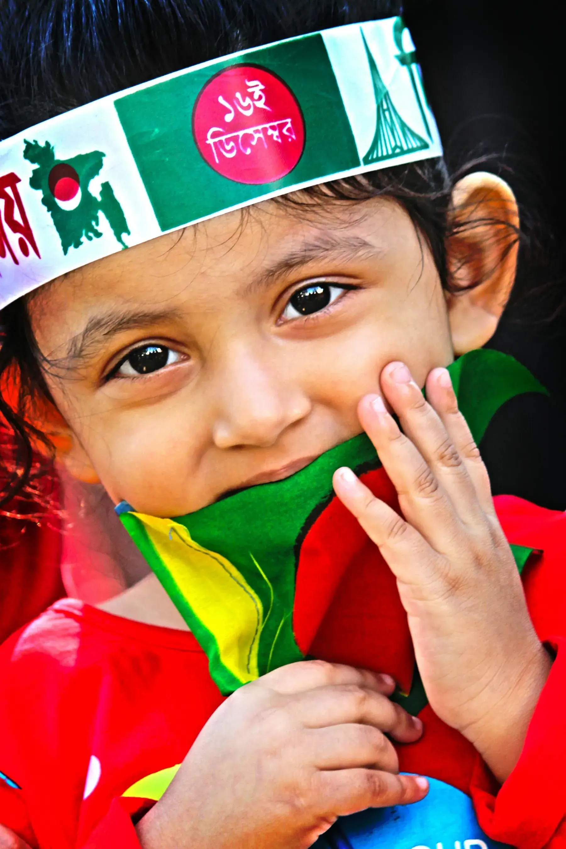 A child wearing a Bengali International Mother Language Day headband