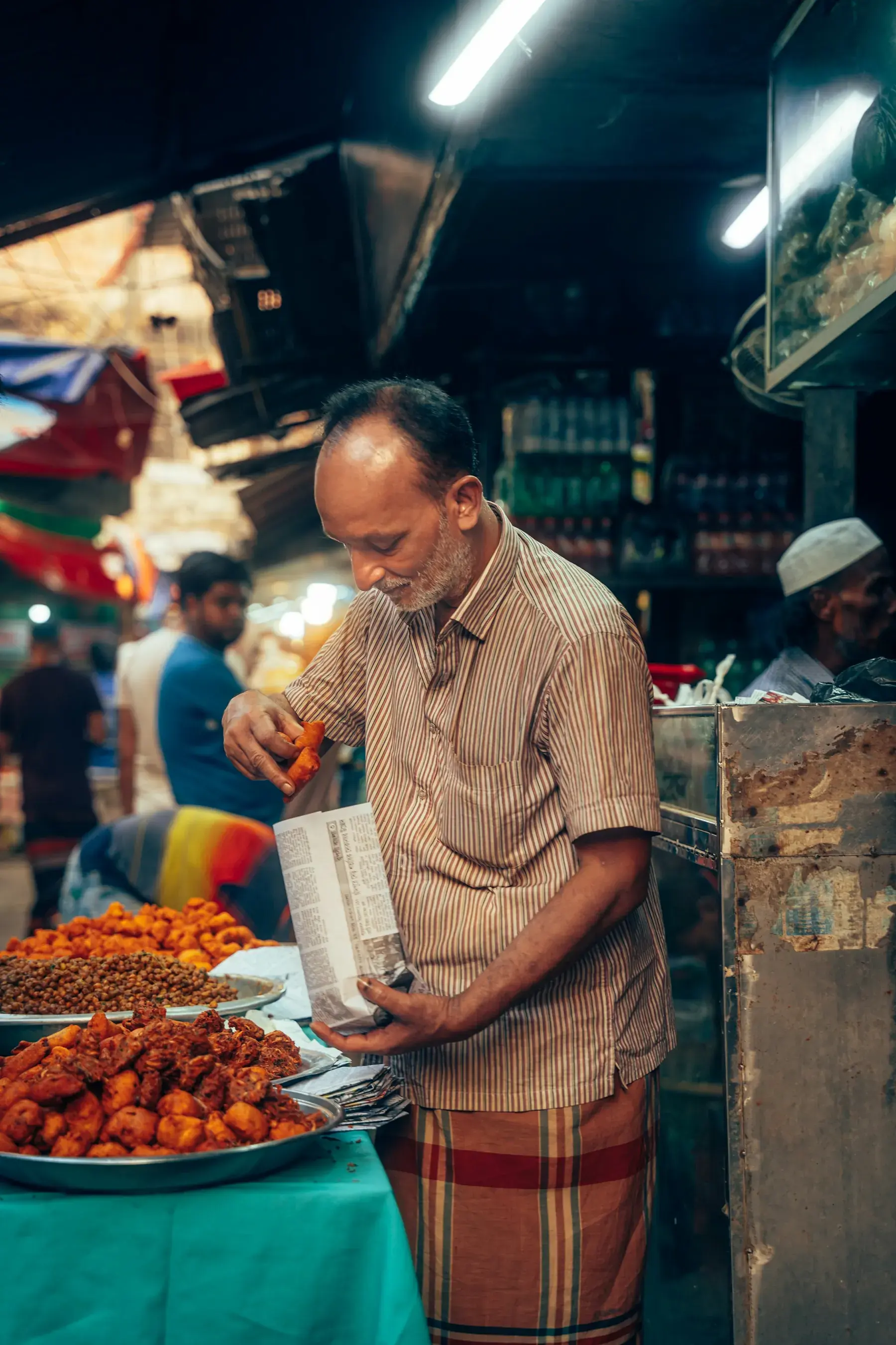 A vendor preparing fried snacks in Chawkbazar
