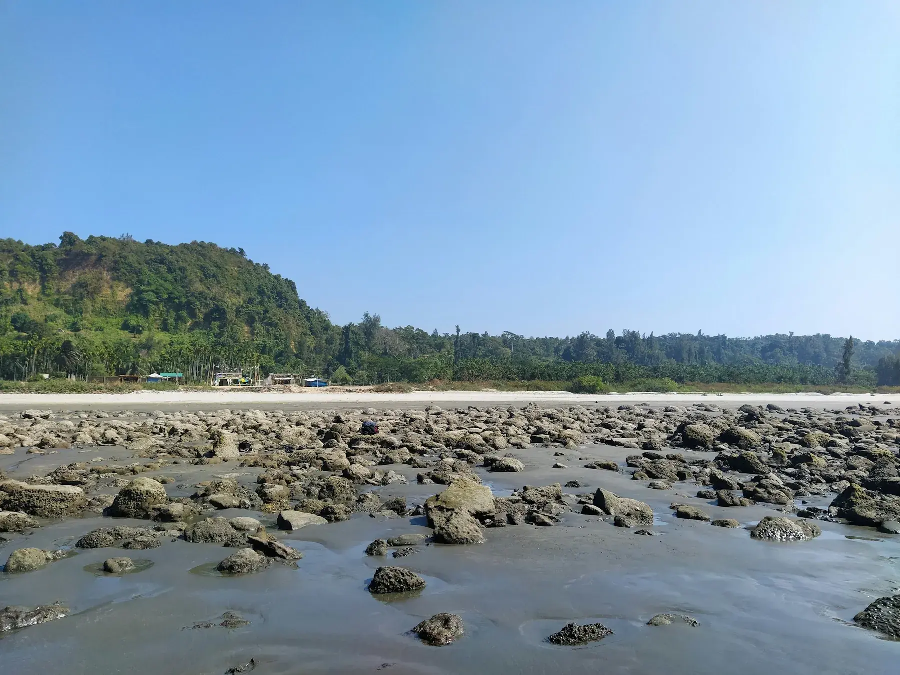 Rocky shoreline and green hills on the Cox's Bazar coast