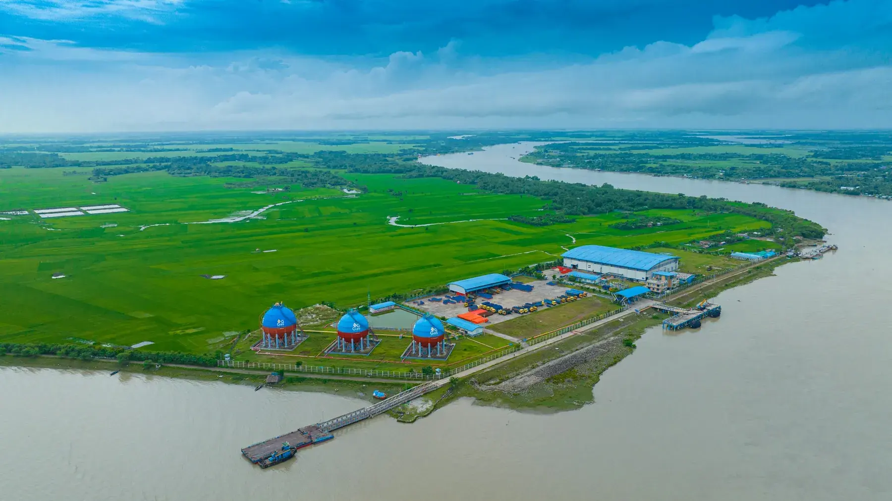 The industrial river edge and green floodplain near Khulna