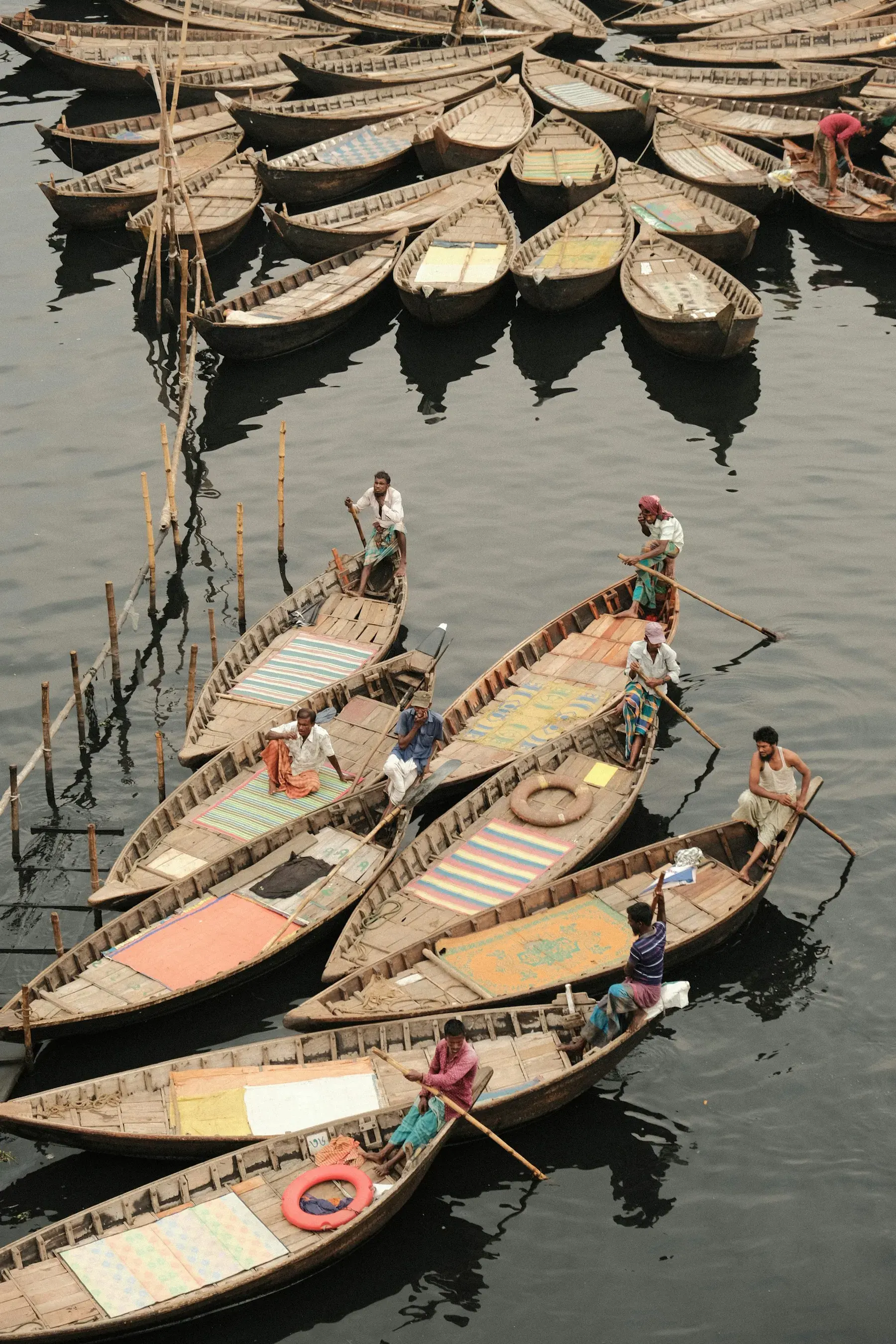 Boatmen working from wooden boats on the Buriganga