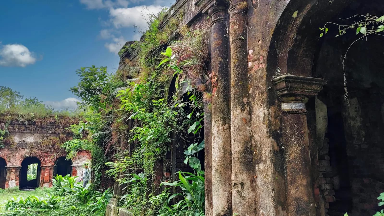Historic brick arches overgrown with greenery in Rangpur, regional travel context for Padma Riverfront