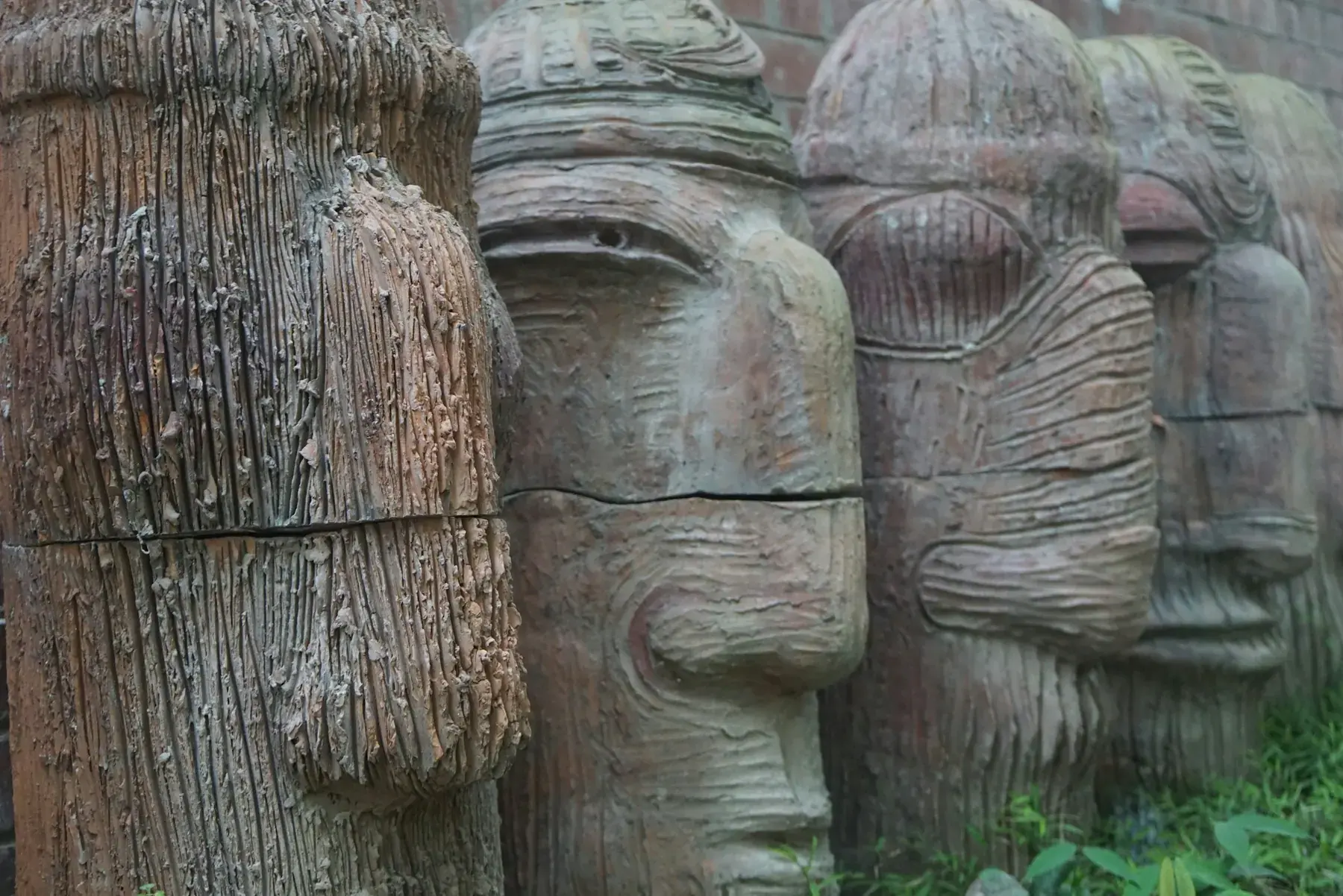 A row of carved faces showing regional craft traditions