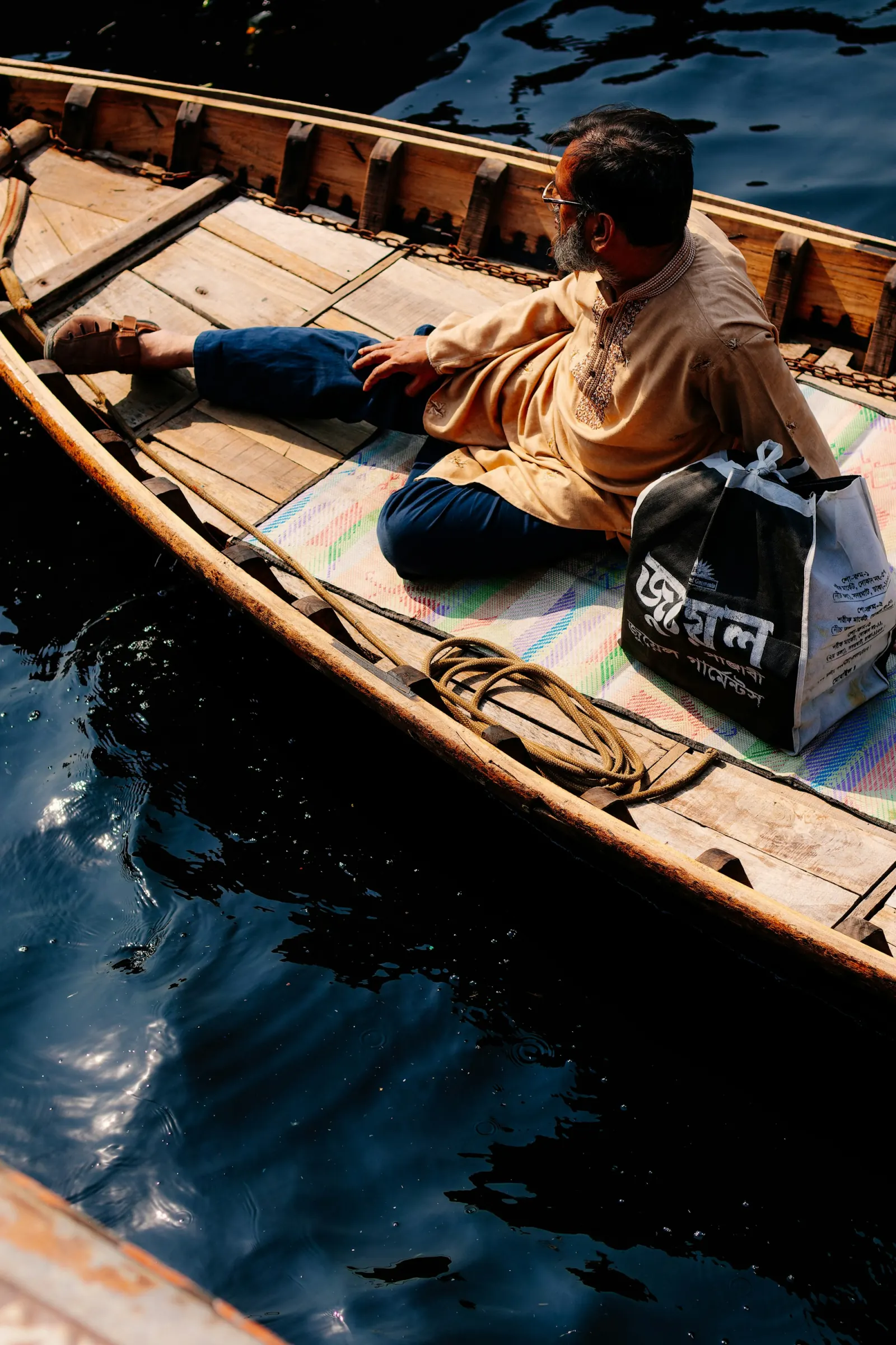 Boatman on the Buriganga River at Sadarghat in Dhaka during the Barishal River & Floating Market Tour